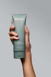 Alpha-H Clear Skin Face & Body Wash tube in de hand