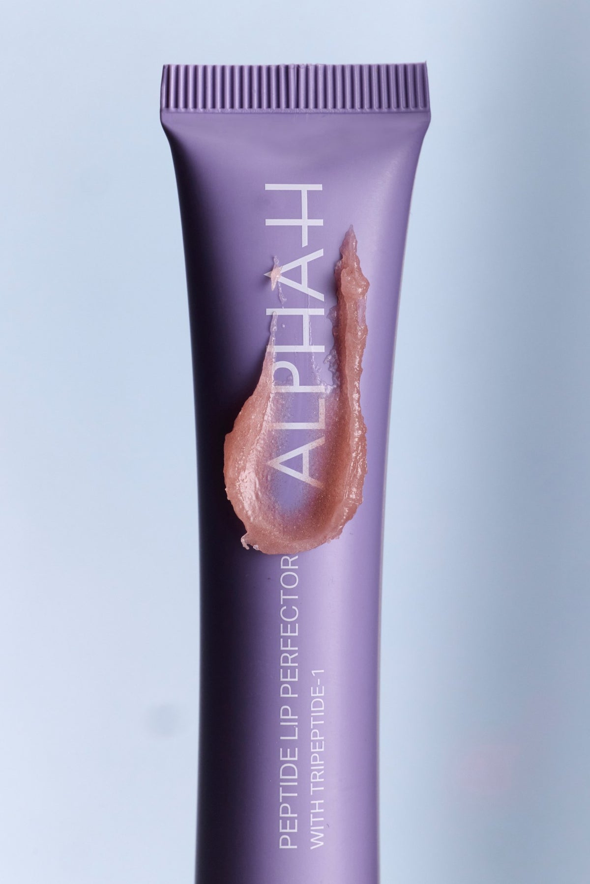 Alpha-H Peptide Lip Perfector tube met textuur